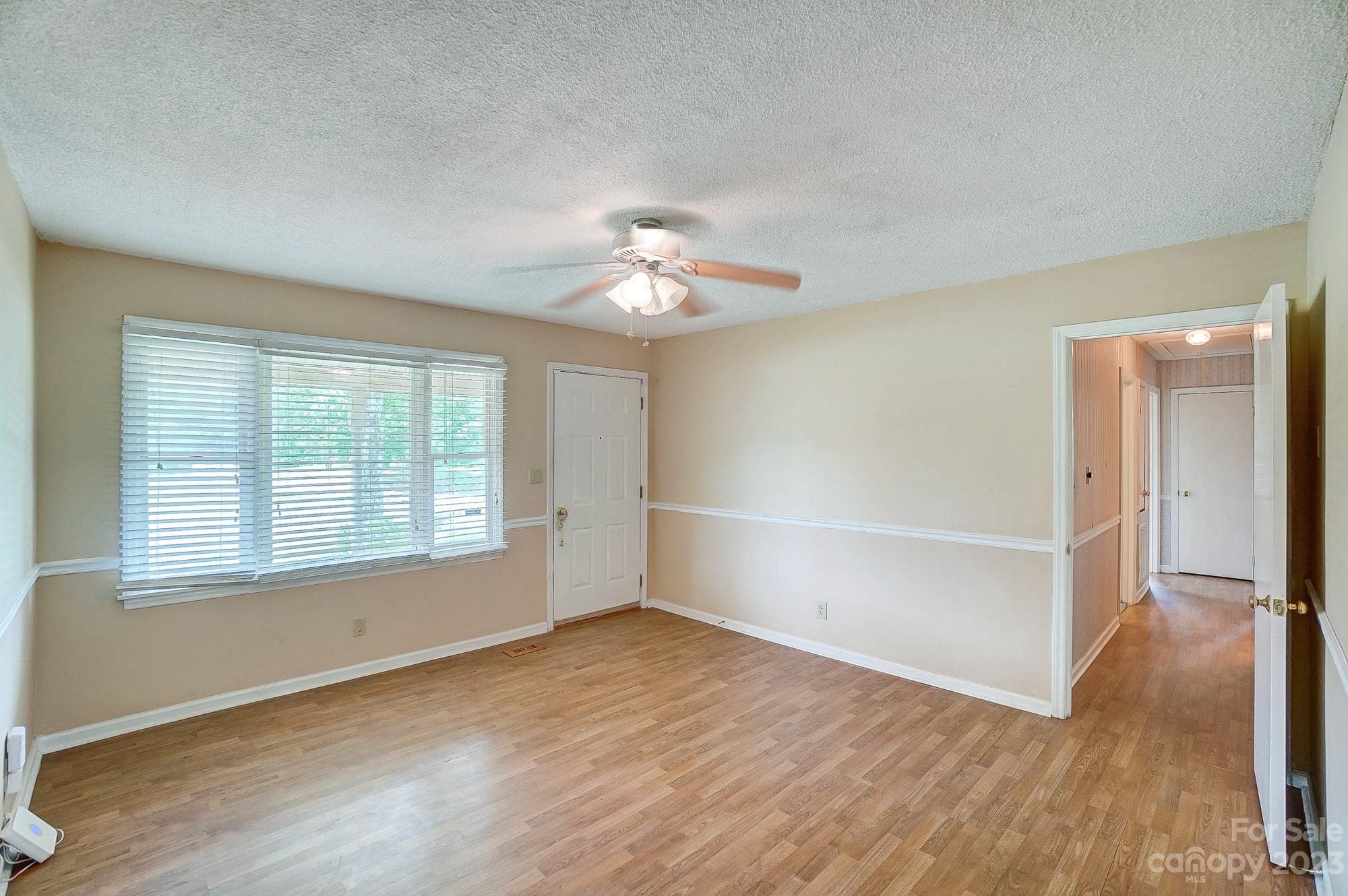 744 Ike Lynch Road Dallas, NC 28034 - Photo 5 of 47 an empty room with wooden floor and windows