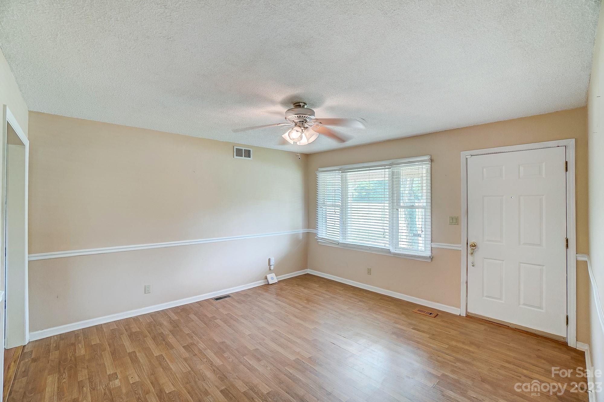 744 Ike Lynch Road Dallas, NC 28034 - Photo 6 of 47 an empty room with wooden floor and windows