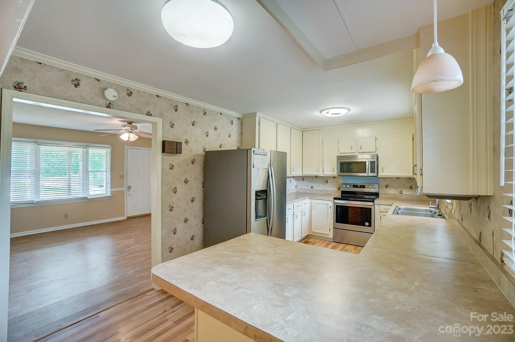 744 Ike Lynch Road Dallas, NC 28034 - Photo 9 of 47 a kitchen with stainless steel appliances a refrigerator sink and stove