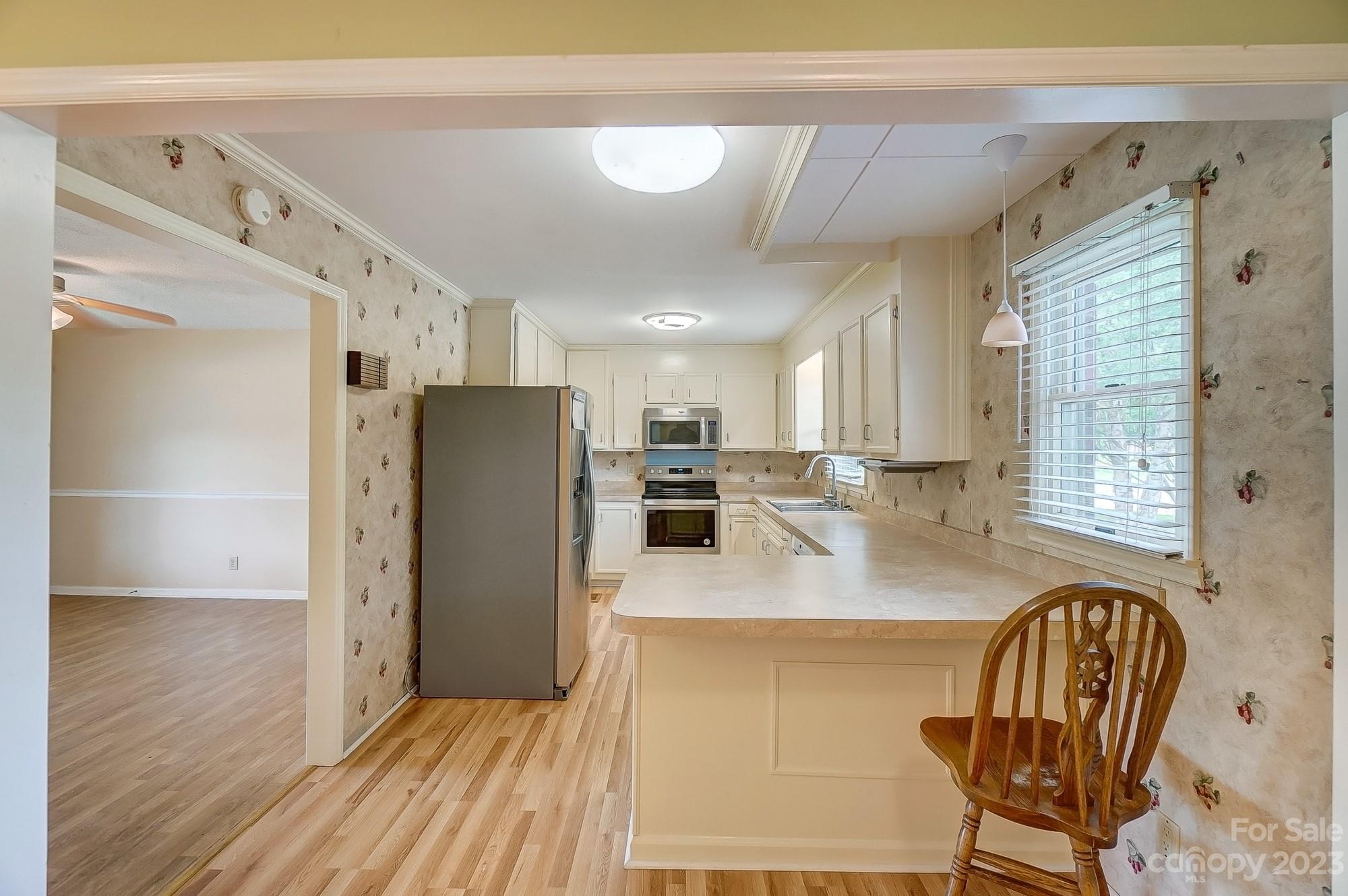 744 Ike Lynch Road Dallas, NC 28034 - Photo 10 of 47 a kitchen with stainless steel appliances granite countertop a refrigerator a stove and a wooden cabinets