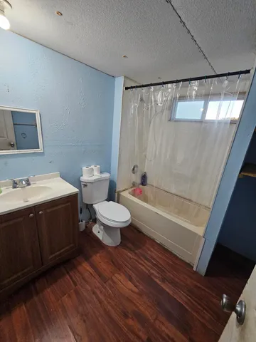 a bath room with a sink and a toilet