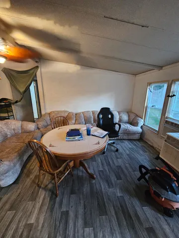 a view of a workspace with furniture and wooden floor