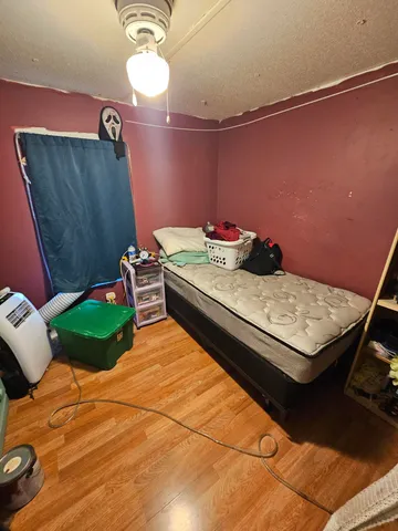 a bedroom with a bed and a mirror