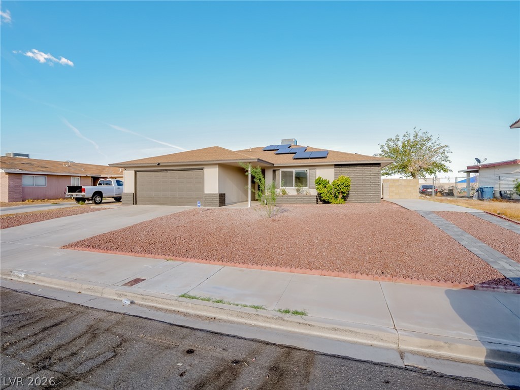 321 Lakehurst Road Las Vegas, NV 89145 - Photo 2 of 33 Low-maintenance desert landscaping fronts this single-story residence with solar.