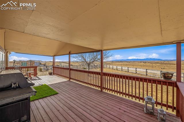 Wooden deck with area for grilling and a mountain view