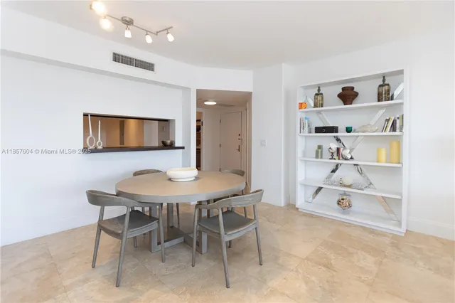 a view of a dining room with a table and chairs