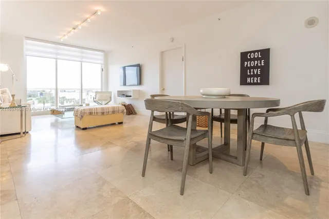 a view of a livingroom with furniture and a large window