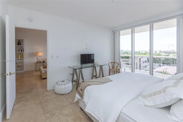a bedroom with bed and glass walk in closet