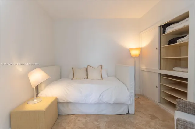 a bedroom with a bed and lamp