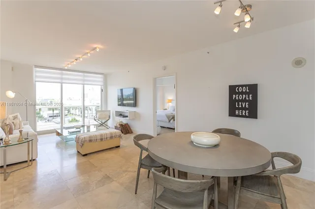 a view of a dining room with furniture and a large window