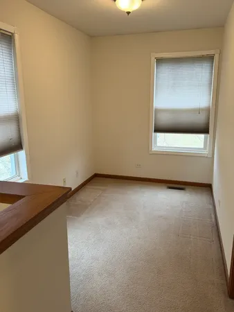 a view of an empty room and wooden floor