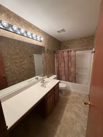 a bathroom with a double vanity sink and a mirror