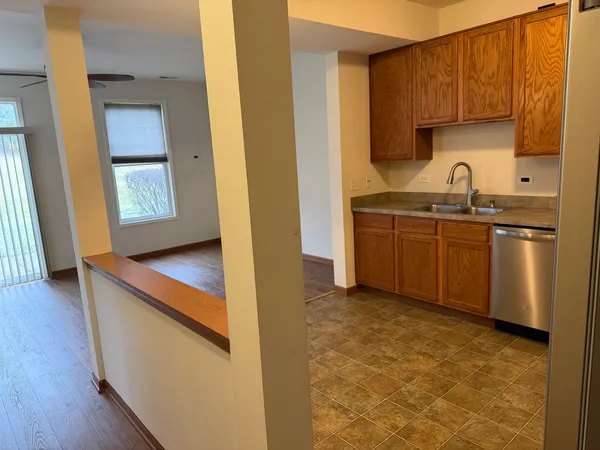 a kitchen with stainless steel appliances granite countertop a sink stove and cabinets