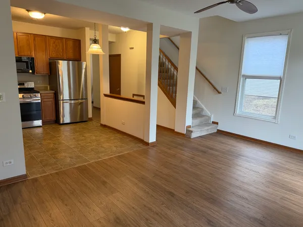 a kitchen with stainless steel appliances a refrigerator and a stove top oven