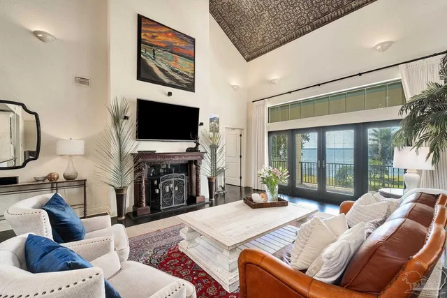 a bedroom with a bed a clock on the wall and a table