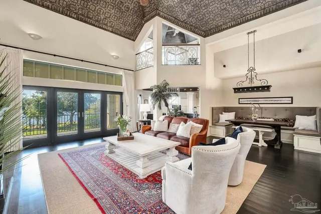 a spacious bathroom with a granite countertop sink a large mirror and a bathtub