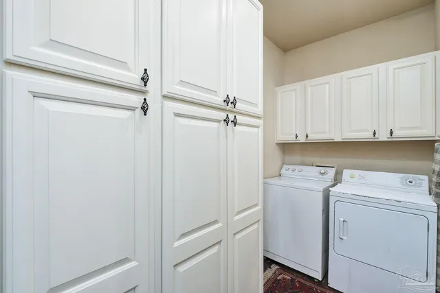a view of a hallway with furniture and wooden floor