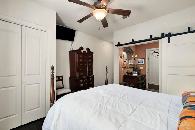 a bathroom with a granite countertop sink a toilet a mirror and shower