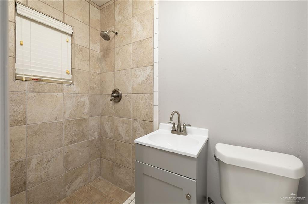 424 Frost Proof Drive Weslaco, TX 78599 - Photo 13 of 21 a bathroom with a sink a toilet and shower