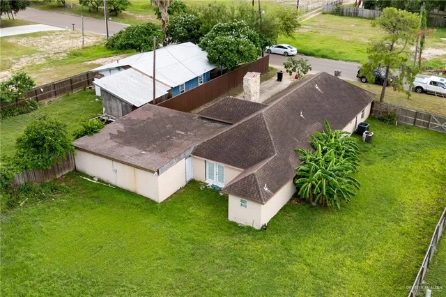 a view of a house with a yard and sitting area