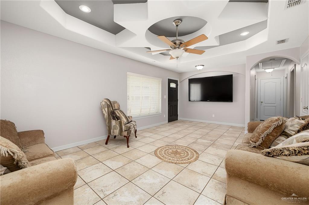 424 Frost Proof Drive Weslaco, TX 78599 - Photo 3 of 21 a living room with furniture and a flat screen tv
