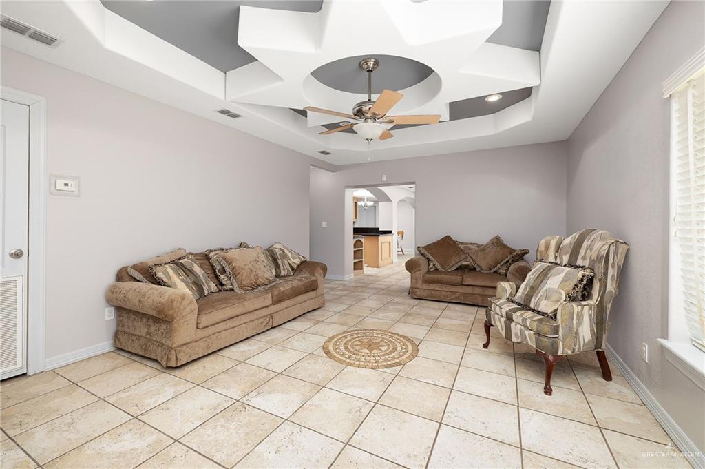 424 Frost Proof Drive Weslaco, TX 78599 - Photo 4 of 21 a living room with furniture and a chandelier