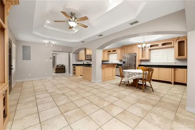 a view of kitchen with furniture and a chandelier fan