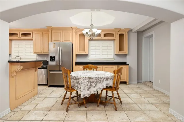 a dining room with furniture and chandelier