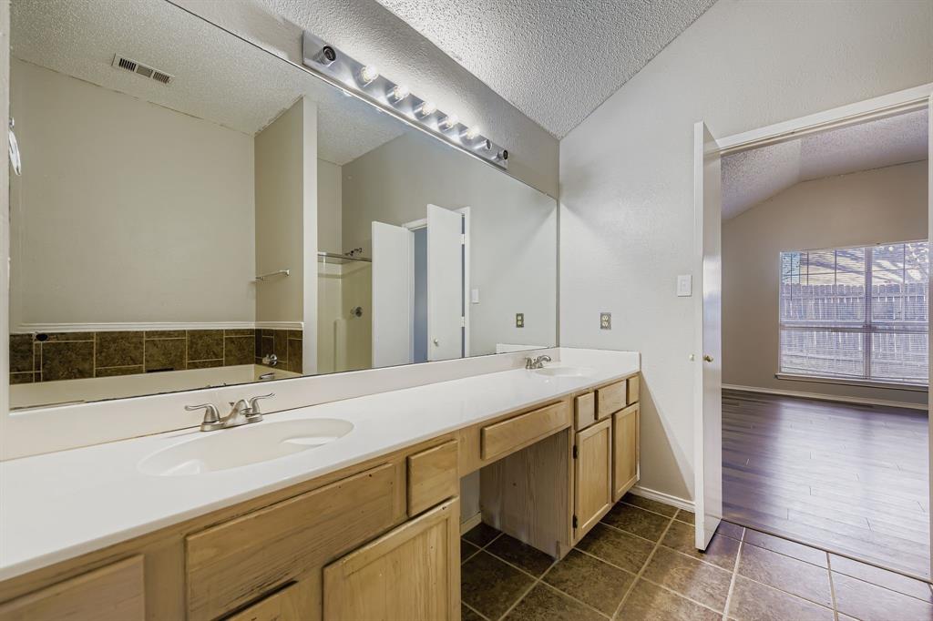 1118 Colbert Lane Duncanville, TX 75137 - Photo 12 of 17 a spacious bathroom with a double vanity sink and a mirror