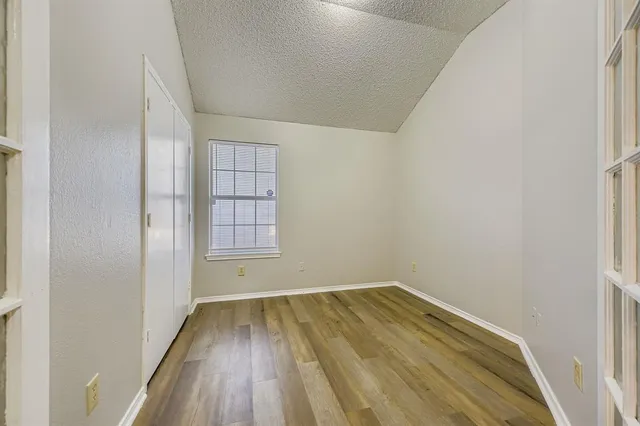 a view of a room with wooden floor and fence