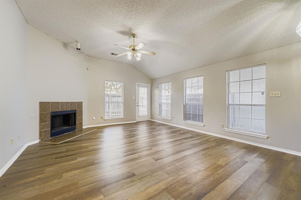 1118 Colbert Lane Duncanville, TX 75137 - Photo 4 of 17 an empty room with wooden floor chandelier and windows