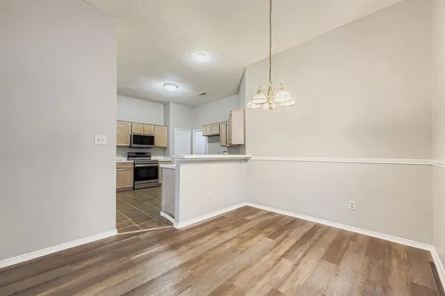 a view of a kitchen with microwave and cabinets