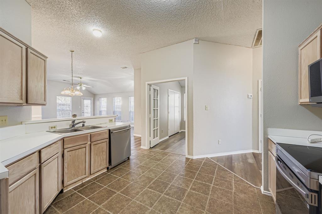 1118 Colbert Lane Duncanville, TX 75137 - Photo 6 of 17 a kitchen with a sink cabinets and window