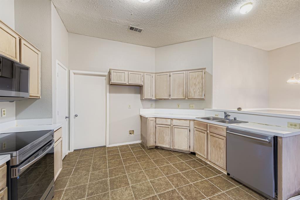 1118 Colbert Lane Duncanville, TX 75137 - Photo 7 of 17 a kitchen with stainless steel appliances granite countertop a sink and stove top oven