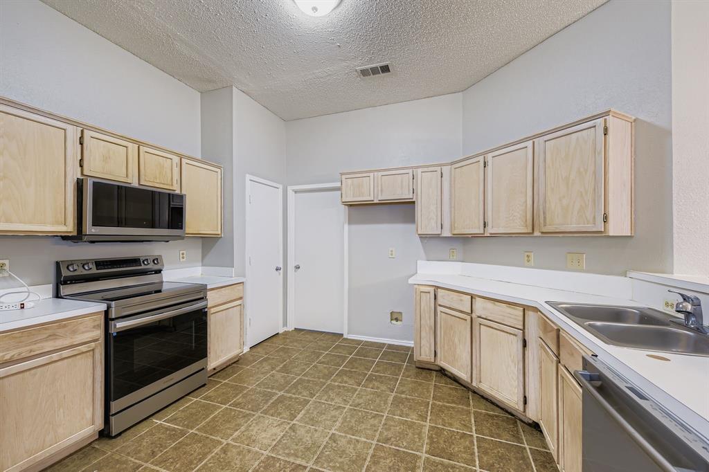 1118 Colbert Lane Duncanville, TX 75137 - Photo 8 of 17 a kitchen with a sink stove and microwave