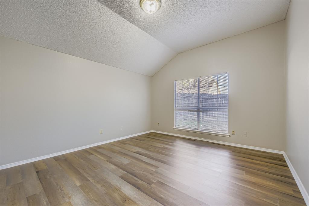 1118 Colbert Lane Duncanville, TX 75137 - Photo 9 of 17 an empty room with wooden floor and windows