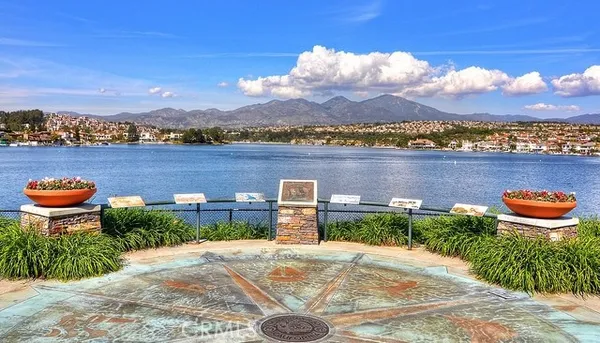 a view of a lake with couches chairs