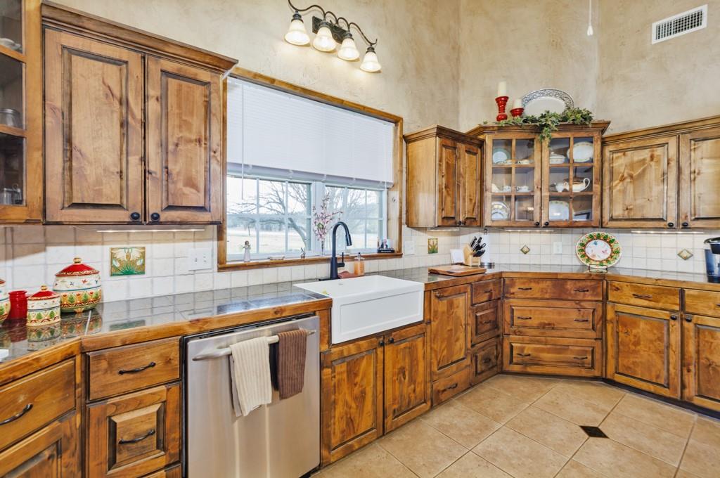 4460 Hildreth Pool Road Bowie, TX 76230 - Photo 10 of 40 a kitchen with stainless steel appliances a sink stove and cabinets