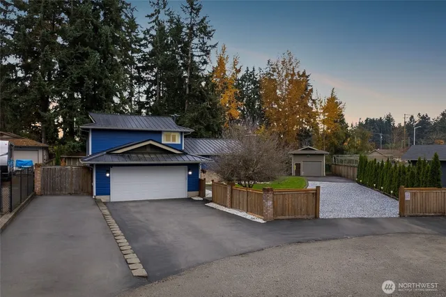 a view of a house with backyard and sitting area