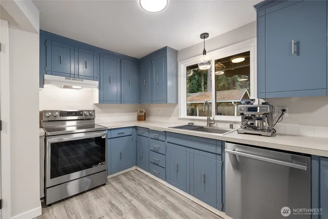 a kitchen with a sink stove and microwave