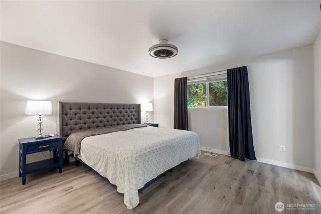 a bedroom with a bed and a window