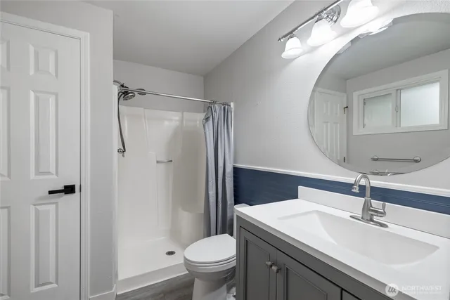 a bathroom with a sink toilet and shower