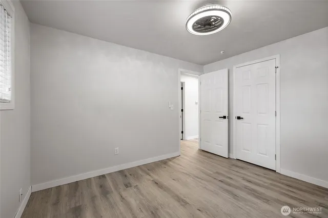 a view of a room with wooden floor and a window