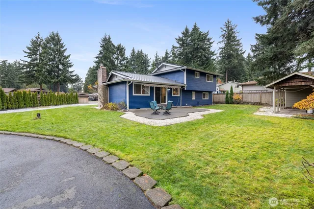 a view of a house with swimming pool and a yard