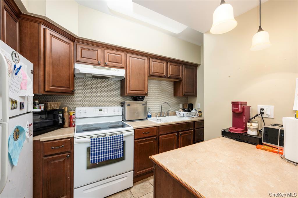6 Old Town Road Beacon, NY 12508 - Photo 39 of 49 a kitchen with a stove a sink and cabinets