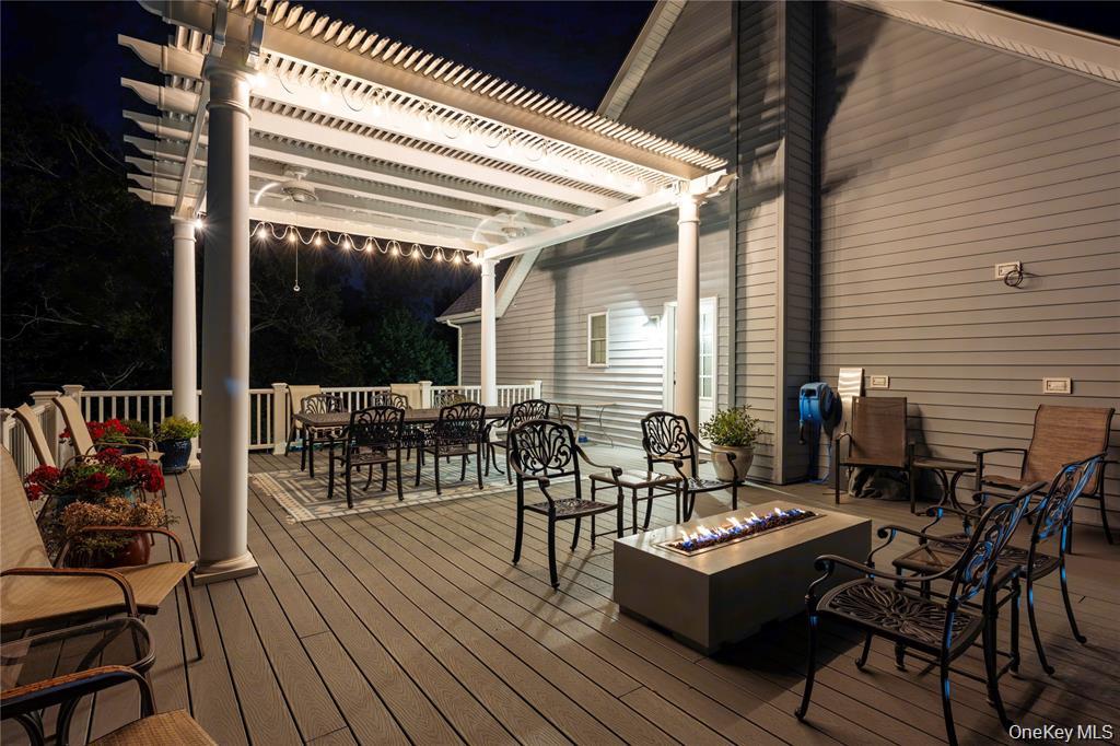 6 Old Town Road Beacon, NY 12508 - Photo 47 of 49 a view of a patio with dining table and chairs with wooden floor and fence