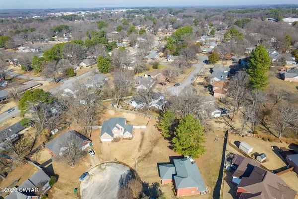 an aerial view of a residential houses with outdoor space