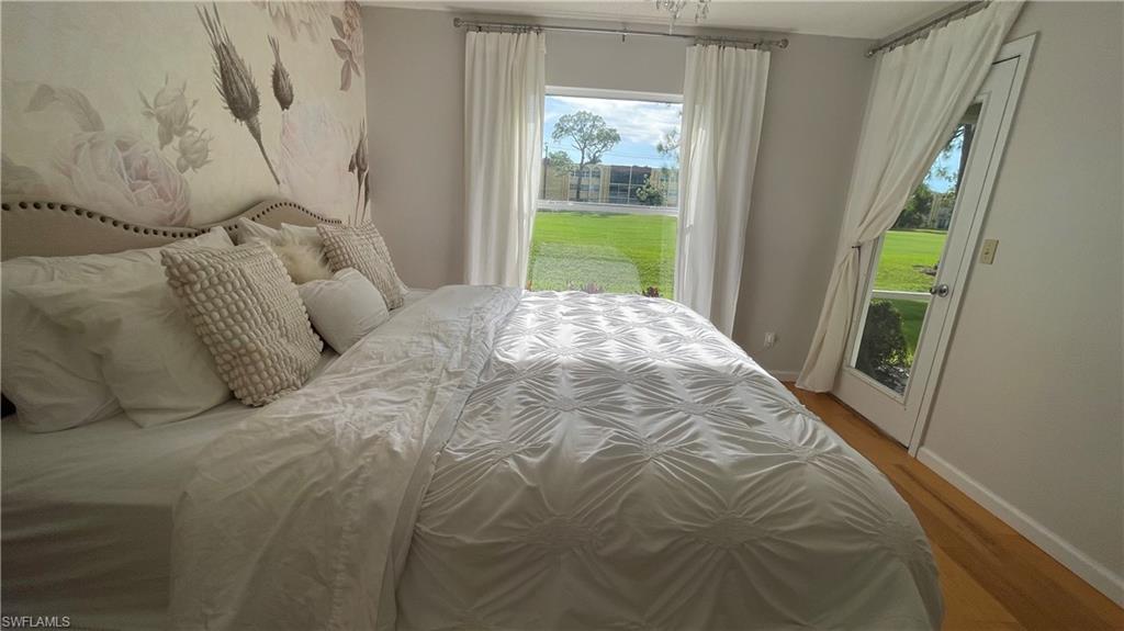 267 Quail Forest Boulevard, Unit 111 Naples, FL 34105 - Photo 16 of 41 a bed sitting in a bedroom next to a window