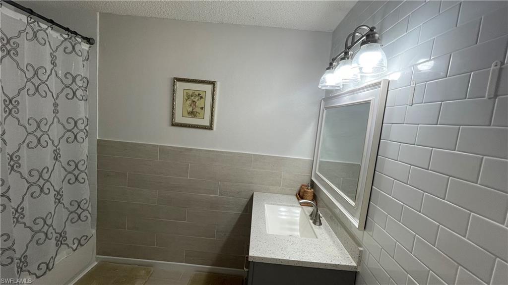 267 Quail Forest Boulevard, Unit 111 Naples, FL 34105 - Photo 23 of 41 a bathroom with a shower