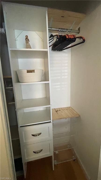 267 Quail Forest Boulevard, Unit 111 Naples, FL 34105 - Photo 29 of 41 a view of walk in closet with clothes and shoes